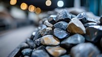 Raw natural stones and minerals with bokeh light effect in background, selective focus on rough crystalline surfaces creates atmospheric composition.