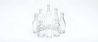 Empty clear glass bottles collection isolated on white background for packaging design and branding projects.