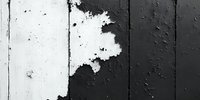 Black and white wooden wall texture with peeling paint, showing contrast between dark and light surfaces. Weathered, rustic background for design projects.