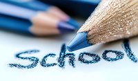 Blue pencil writing word school on white paper with soft focus background, macro photography showing texture and detail of wooden pencil and writing.