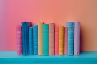 Row of colorful hardcover books standing on turquoise shelf against pink and orange gradient background, creating minimalist composition for education concept.