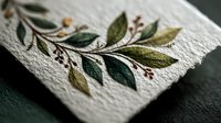 Elegant botanical illustration of green leaves and red berries on textured white paper, showcasing delicate natural elements for stationery design.