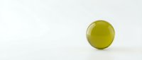 Single green olive isolated on white background for culinary design and food photography projects.