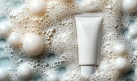 White cosmetic tube mockup on foamy soapy background with bubbles and soft spheres, suitable for skincare product presentation and beauty advertising.