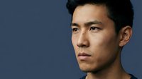 Asian male, approximately 30-35 years old, with short dark hair and neutral expression, isolated against solid blue background for portrait and headshot use.