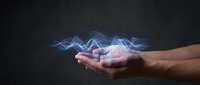Hands holding glowing blue energy waves with electric lightning effects on dark background for technology and power concepts.