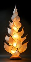 Illuminated artistic lamp with leaf-shaped elements creating warm glowing sculpture against dark background, modern decorative lighting design for interior spaces.