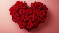 Heart shaped arrangement of vibrant red roses on pink background, romantic floral composition for Valentine's Day, weddings, and love celebrations.