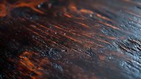 Dark wooden texture with orange highlights and deep grooves creating dramatic contrast, suitable for rustic design backgrounds and natural material patterns.