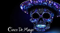 Ornate sugar skull with decorative sombrero adorned in purple and blue jewels for Cinco de Mayo celebration on dark background.