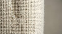 Natural burlap fabric texture with visible fibers and weave pattern for rustic crafting and eco-friendly design projects.