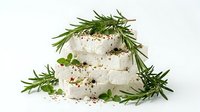 Creamy fresh cheese with rosemary and herbs on white background, isolated for culinary design, food packaging, and recipe content.