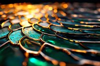 Abstract macro photography of emerald green liquid surface with golden light reflections creating dynamic pattern of curves and ripples in dark background.