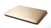 Closed gold laptop computer isolated on white background, ready for design mockups and technology presentations.