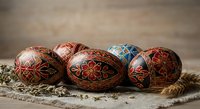 Traditional Ukrainian Easter eggs with intricate folk patterns and vibrant colors arranged on rustic burlap fabric for holiday celebration and cultural heritage.