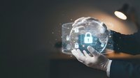 Businessman holding glowing digital sphere with cybersecurity lock icon and network connections representing data protection and secure technology solutions.