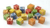 Colorful wooden alphabet blocks with letters and numbers scattered on white background. Educational toys for children learning and development.