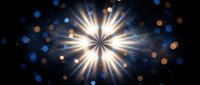 Brilliant starburst light explosion with radiant beams and colorful bokeh effects on dark background for festive celebrations and cosmic designs.