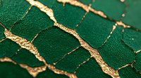 Luxurious emerald green cracked texture with golden veins running through deep fissures creates elegant abstract pattern on textured surface. Macro photography.