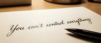 You can't control everything handwritten motivational quote on paper with elegant black pen for mindfulness and personal development concepts.
