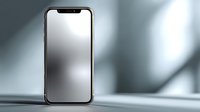Modern smartphone with blank screen standing upright on reflective surface against blurred gray background with soft shadows and light effects.