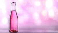 Glass bottle with pink liquid against blurred pink bokeh background, minimalist composition for beverage and product photography.