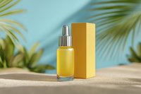 Yellow serum bottle with dropper and gold packaging on sand against blue background with tropical palm leaves shadows.