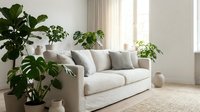 Bright living room with beige sofa, potted green plants, natural light from windows, and minimalist home decor for interior design and lifestyle content.