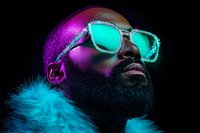 African American man with beard wearing glowing turquoise sunglasses and fur coat against dark background, illuminated by vibrant purple and blue neon lighting effects.