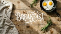 Breakfast lettering on rustic wooden table with fried eggs in cast iron skillet, rosemary sprigs, and linen napkin, top view.