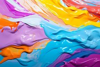 Vibrant swirls of colorful paint create dynamic flowing patterns with purple, yellow, blue, and orange hues mixing together in abstract liquid art composition.