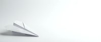 White paper airplane on clean minimalist background with soft shadow, symbolizing travel, dreams, and new beginnings in business presentations.