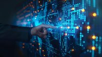 Business analyst pointing at digital stock market data visualization, financial graph charts and economic indicators on futuristic blue interface with glowing dots pattern.
