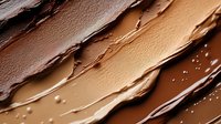 Creamy chocolate and caramel swirls with golden droplets creating luxurious dessert texture for confectionery and gourmet food packaging designs.