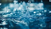Macro shot of water drop splash creating crown shape with multiple droplets against blue aqua background, frozen motion capturing liquid dynamics.