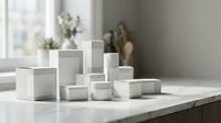 White cosmetic jars and containers arranged on marble surface in bright natural light for skincare product packaging and beauty brand mockup.