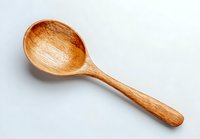 Wooden cooking spoon isolated on white background, eco-friendly kitchen utensil for sustainable cooking and food preparation.