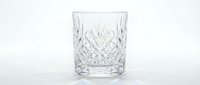 Crystal cut glass tumbler with diamond pattern design isolated on white background for luxury beverage service and elegant dining presentations.