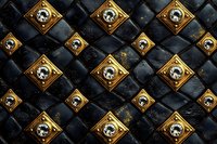 Luxury gothic seamless pattern with golden skull medallions on black quilted leather background for premium design projects.
