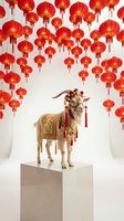 Festive goat in traditional golden costume standing on pedestal surrounded by glowing red lanterns for lunar new year celebration and holiday decorations.