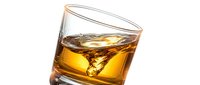 Whiskey glass with ice cubes on white background, isolated for beverage, alcohol, and bar design projects.