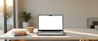 Modern laptop with blank white screen on wooden desk in bright home office workspace with coffee cup and plant for remote work presentations.