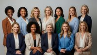 Diverse group of professional businesswomen in corporate attire posing together for team portrait in modern office setting for leadership and teamwork concepts.