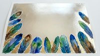 Watercolor feathers border frame on textured paper background with blue green brown plumage elements for bohemian design projects and natural decorative artwork.
