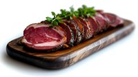 Sliced cured meat with herbs on wooden cutting board isolated on white background ready for culinary design and restaurant menu presentations.