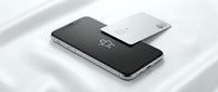 Sleek silver smartphone with a credit card on a soft white silk background, showcasing modern mobile payment and digital banking technology.