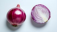 Fresh red onion whole and half cut showing layered interior texture on white background, isolated food photography for culinary and cooking concepts.