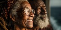 Elderly African woman with glasses smiling warmly, traditional headwrap, wise grandmother portrait for family, cultural heritage, senior lifestyle content.