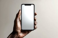 African American male hand holding modern smartphone with blank white screen mockup against neutral beige background for app presentation and digital design.