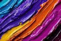 Vibrant diagonal stripes of colorful oil paint texture with blue, purple, orange, yellow and pink hues create dynamic abstract background for creative design projects.